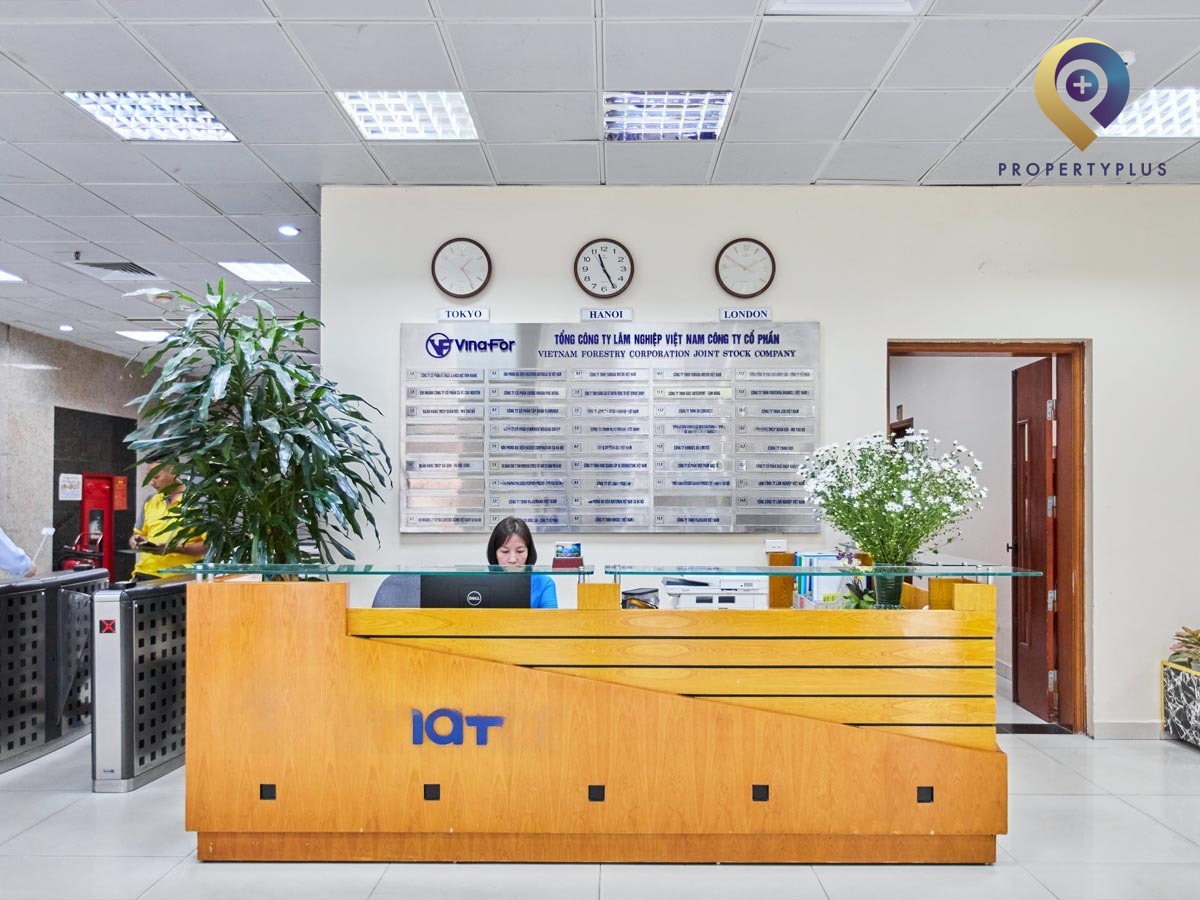 Reception desk of Vinafor Building with modern interior and welcoming staff.